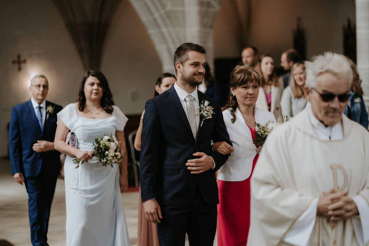 Mom leads the groom to the altar.