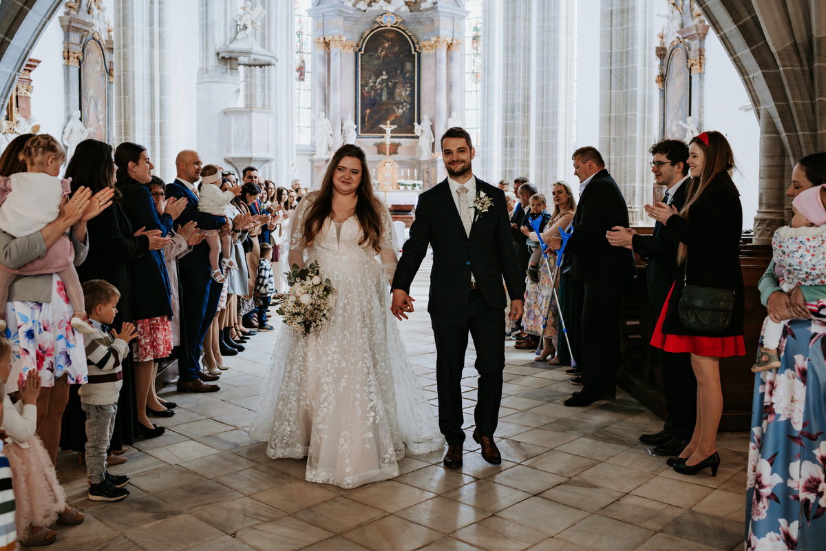 The bride and groom walk down the aisle as husband and wife.