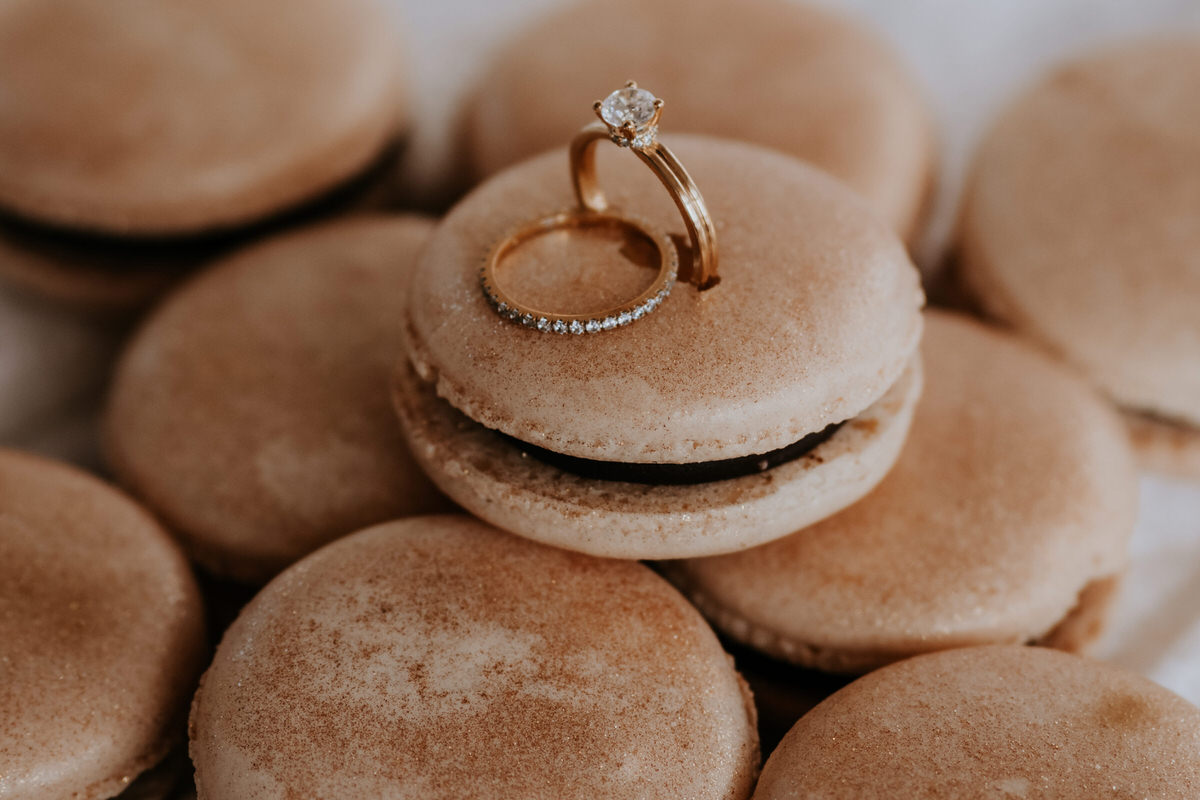Creative photo of wedding rings - rings stuck in a macaroon.