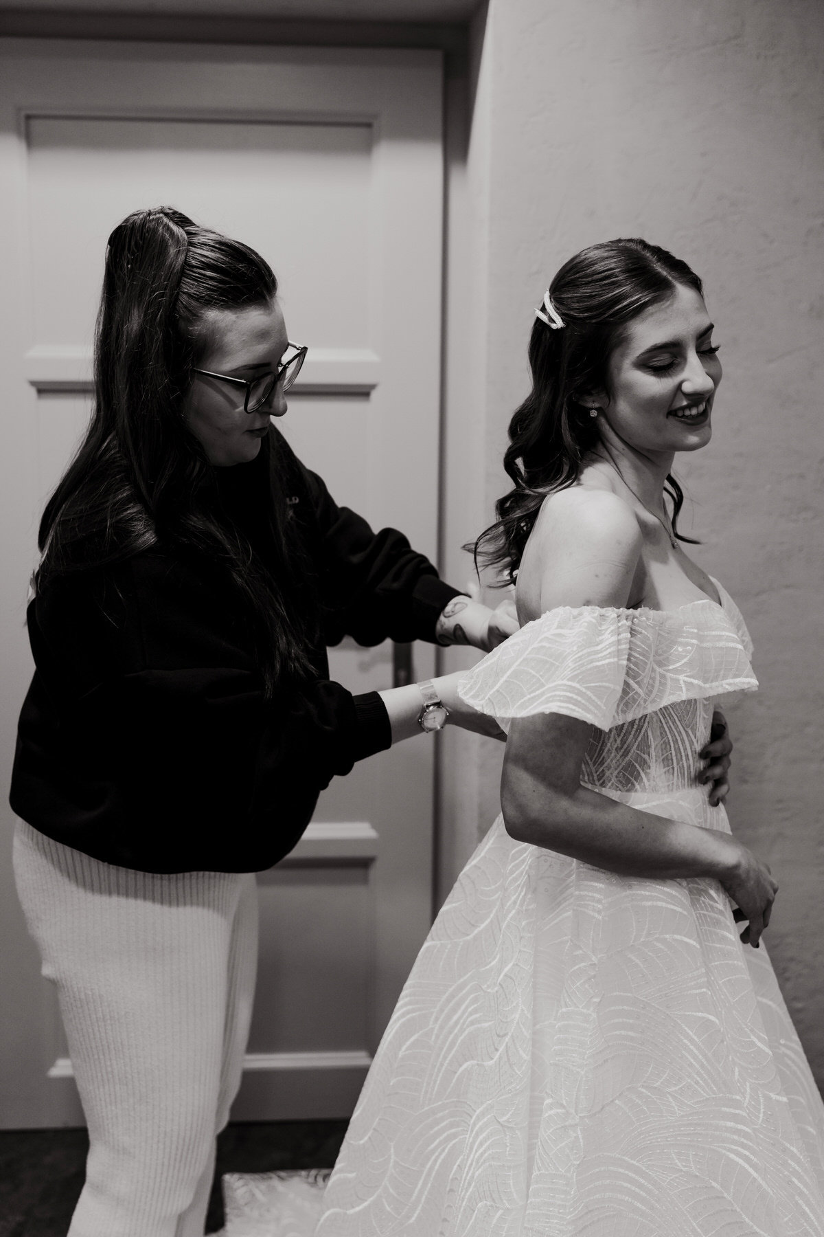 The bride puts on her wedding dress.