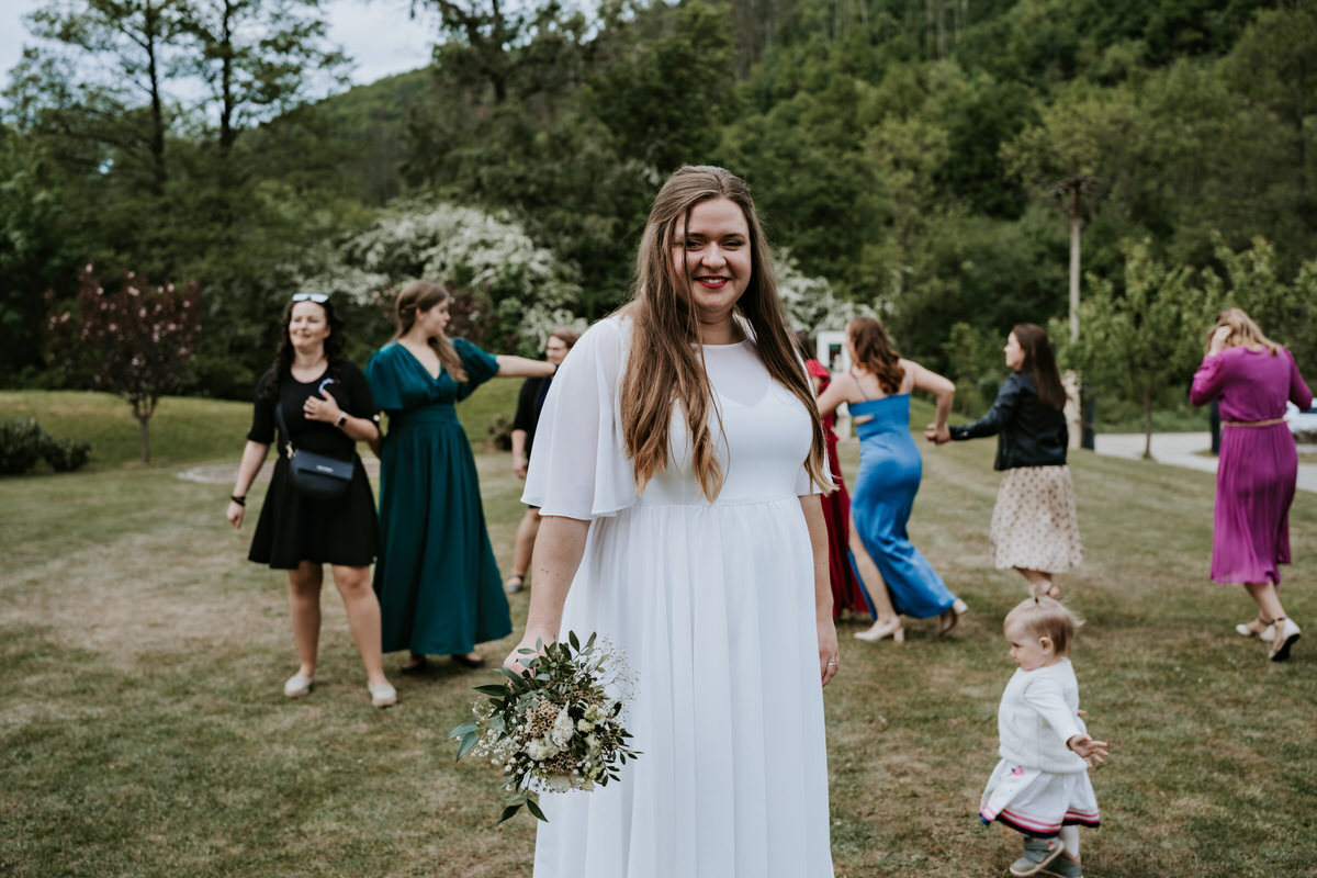 The bride is preparing to throw the bouquet.