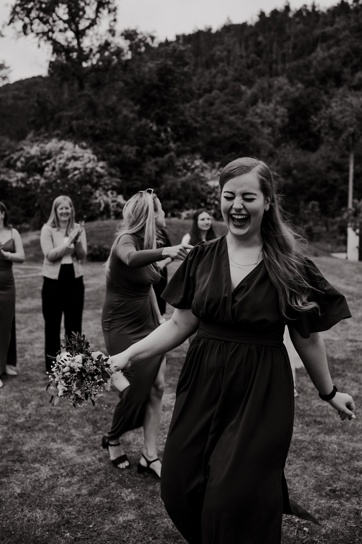 The bridesmaid caught the wedding bouquet.