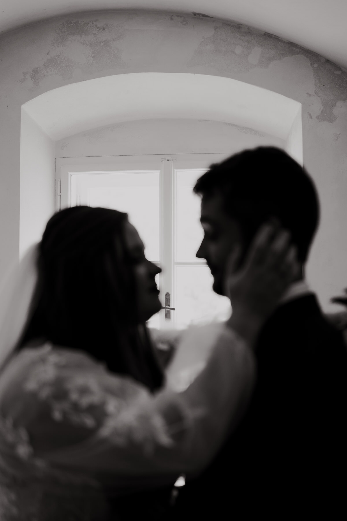 Doubravník Parish - newlyweds taking pictures against the window.