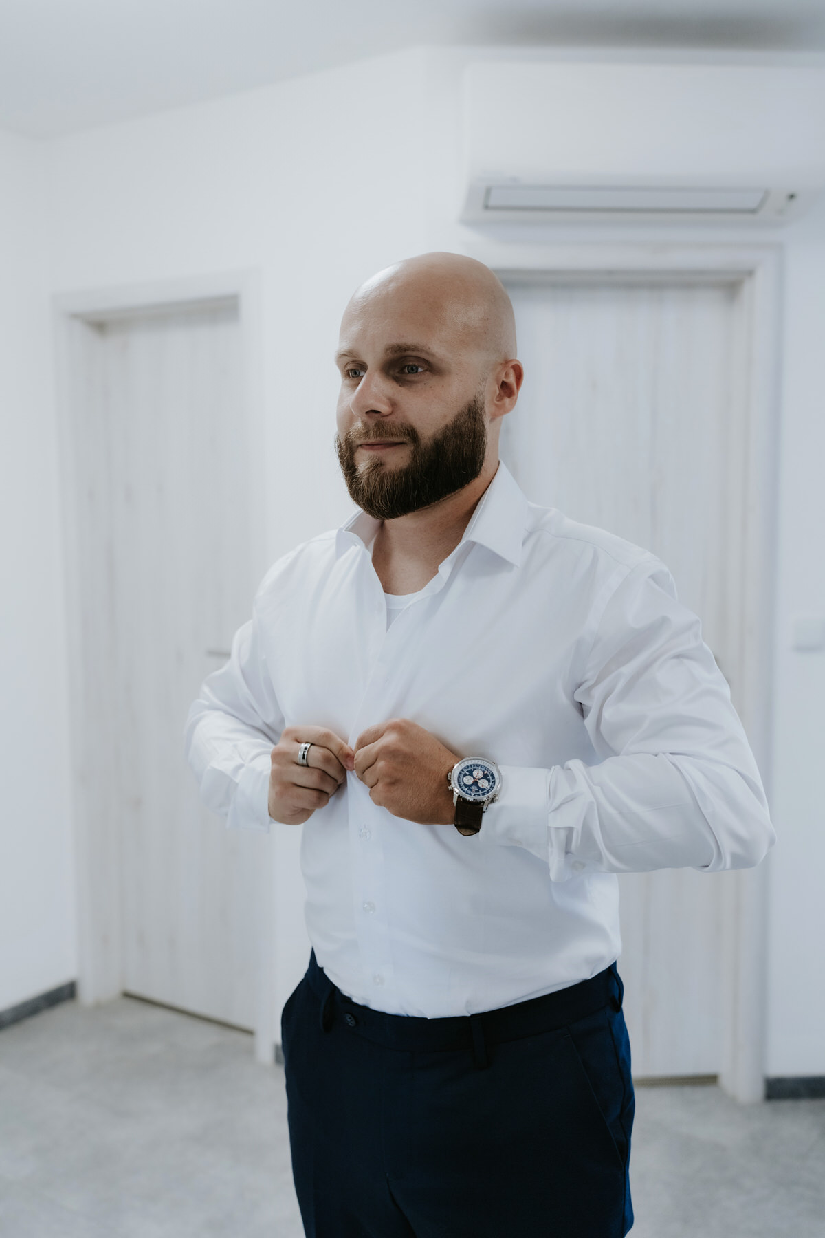The groom is getting dressed.
