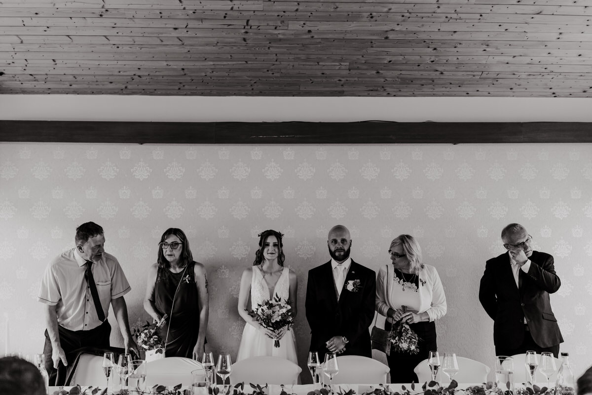 A snapshot of wedding guests sitting at the table.