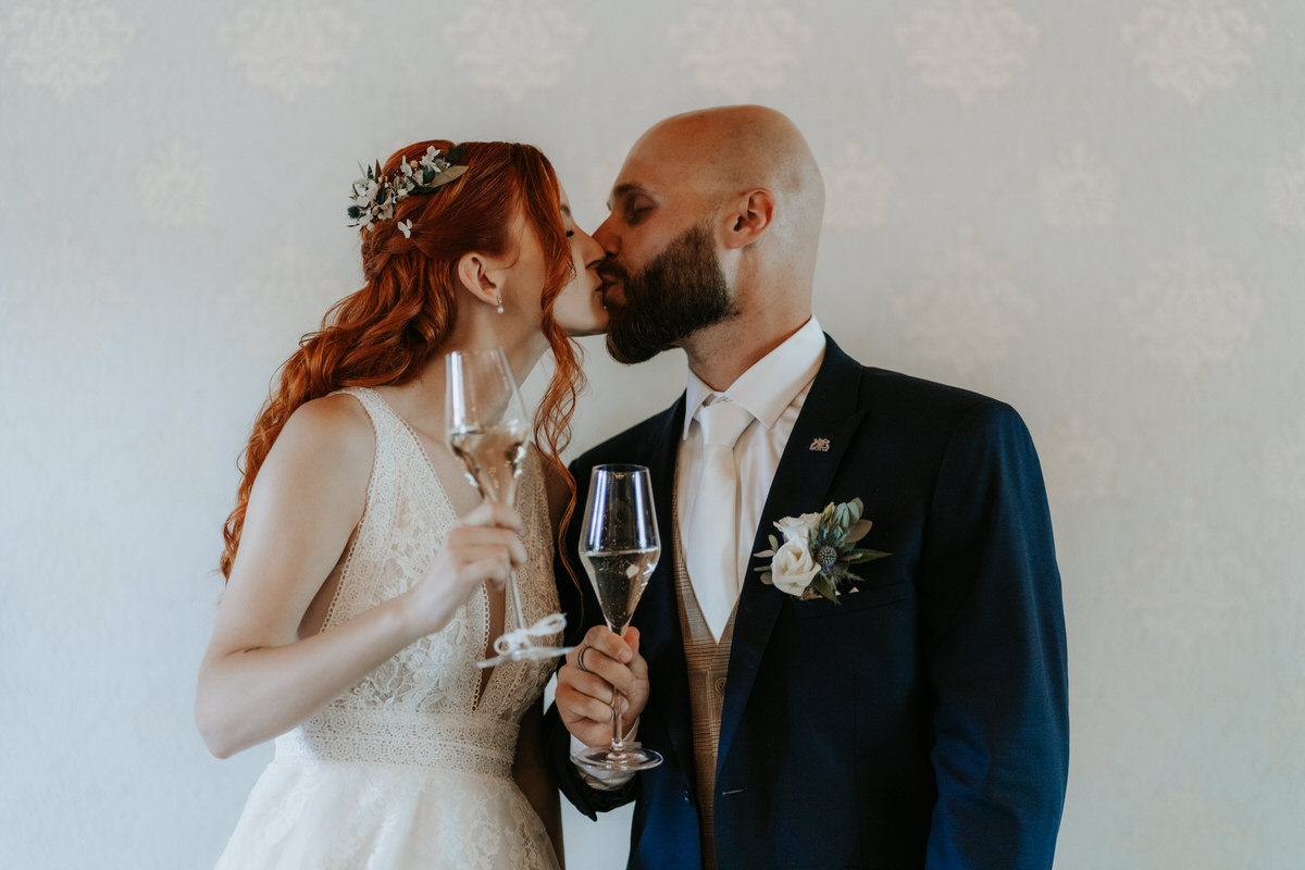 The newlyweds share a kiss during a toast.