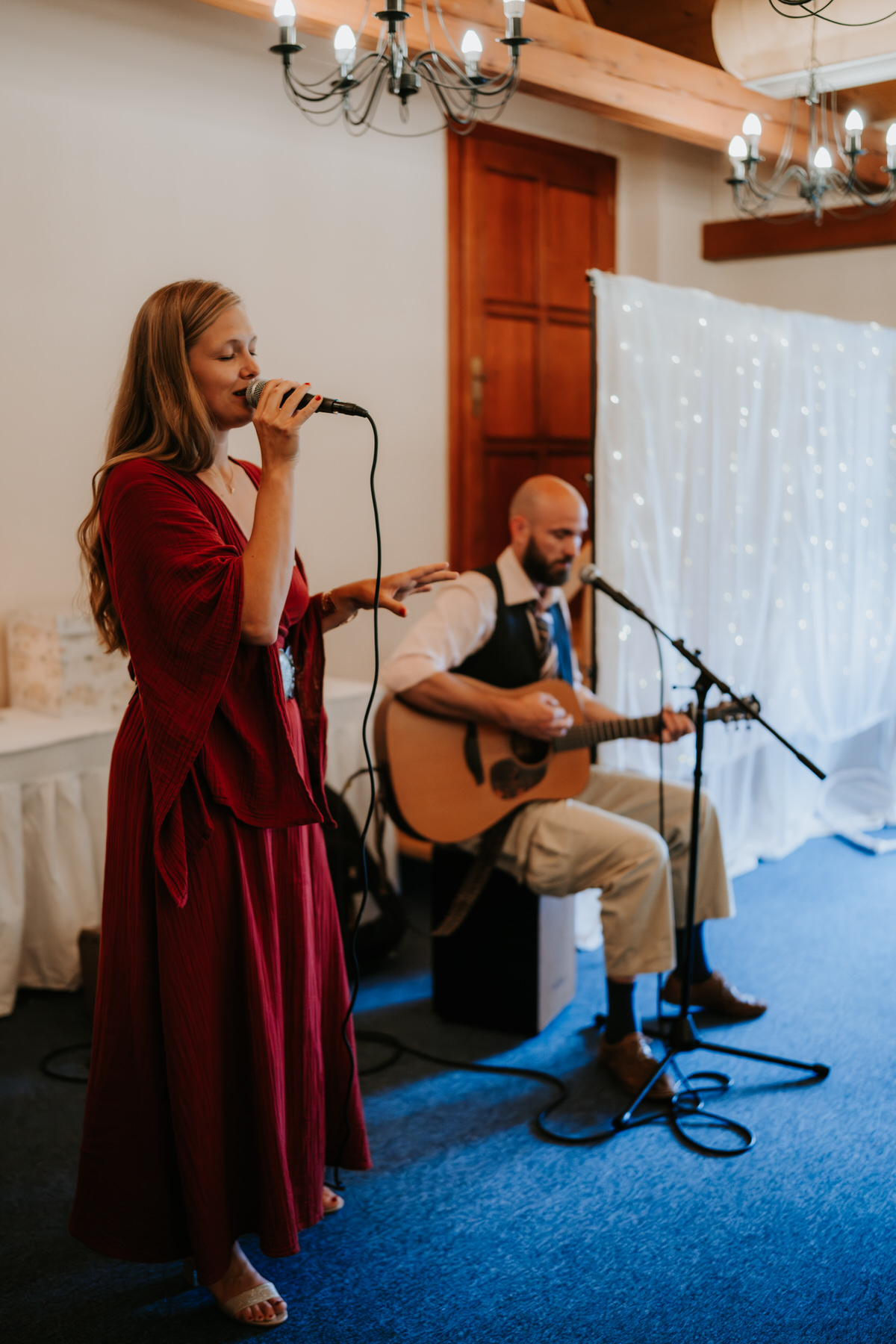 Friends of the newlyweds play and sing for them during their first dance.