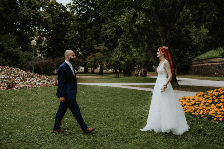 The bride and groom kiss in the park during their photo shoot.
