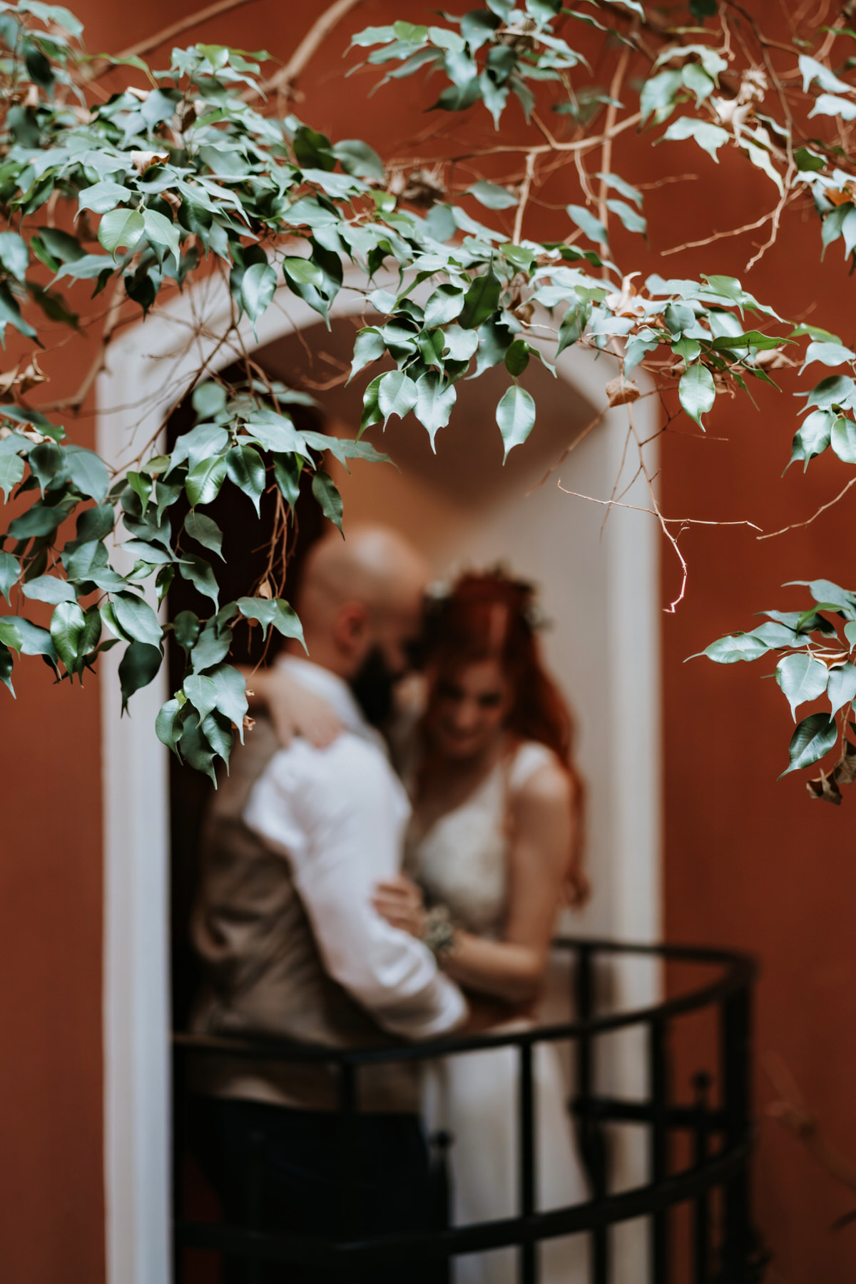 An original creative shot of the newlyweds standing on the balcony at Hradec Králové.